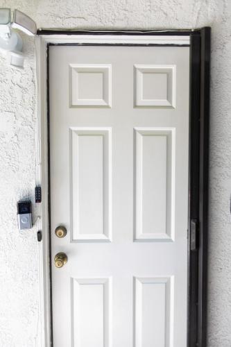 a white door on a white wall at Stylish Casita min from the beach ! in San Juan Capistrano