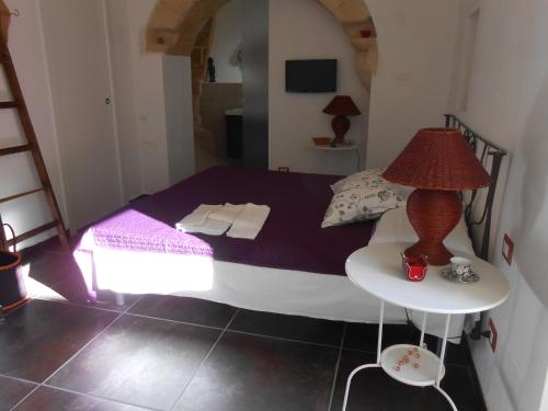 a bedroom with a bed and a table with a lamp at Matera's B&B in Matera