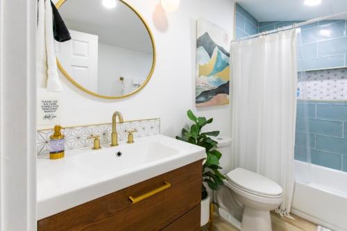 a bathroom with a sink and a toilet and a mirror at Stylish Casita min from the beach ! in San Juan Capistrano