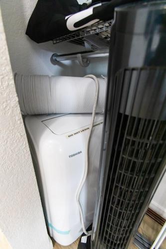 a white hair dryer sitting in a room at Stylish Casita min from the beach ! in San Juan Capistrano