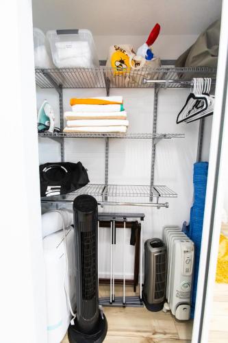a closet filled with shelves and a desk at Stylish Casita min from the beach ! in San Juan Capistrano