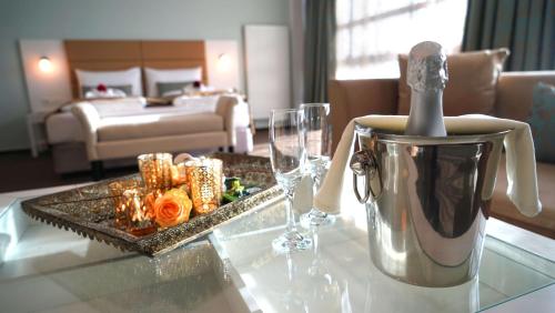 a hotel room with a table with a tea kettle and glasses at Hotel Class in Hamburg