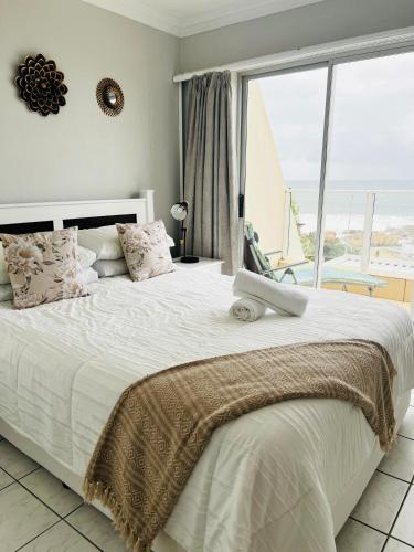 a bedroom with a large bed with a large window at 13 Chesapeake Bay in Margate