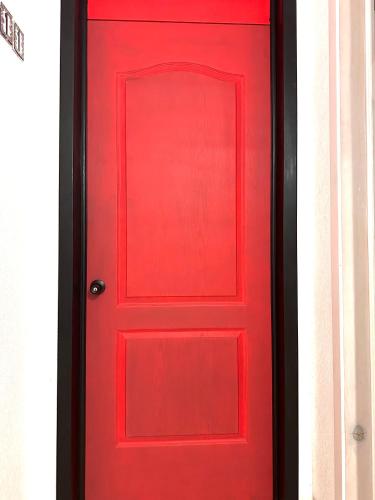 a red door with a black frame at Hotel & Suites Cerro Roj0 in Tlatlauquitepec