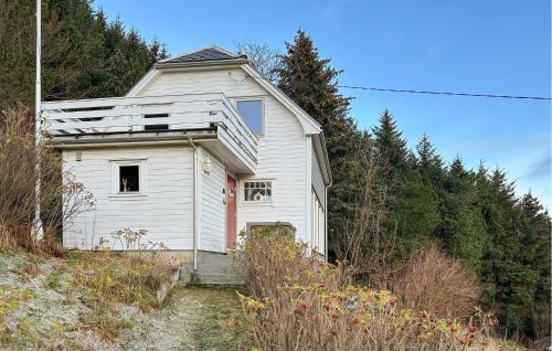 an old white house on the side of a hill at Cozy Home In Nerlandsøya Grunnkrets in Kvalsvik