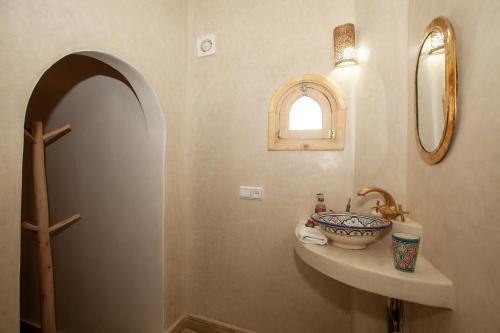 a bathroom with a sink and a mirror at riad dar wlidati in Marrakech