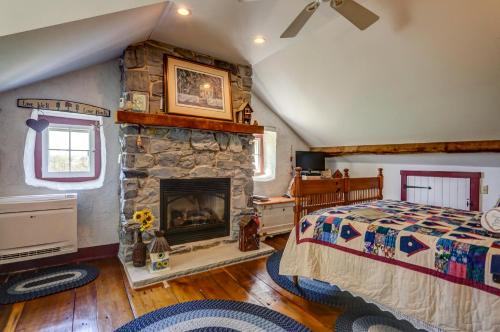 a bedroom with a stone fireplace and a bed at Osceola Mill House Bed and Breakfast in Gordonville