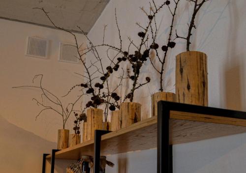 a vase with branches on top of a wooden box at Котеджі Грань in Bukovel