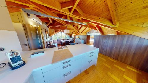 a kitchen with a white counter top and wooden ceilings at Apartaments Boutique la Torreta del Llac in Puigcerdà
