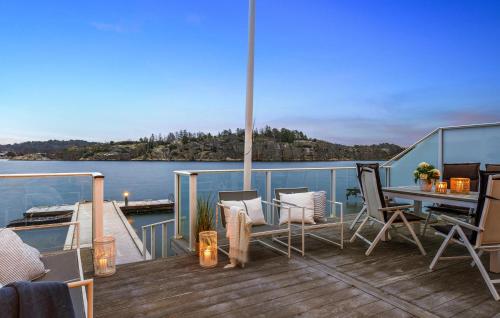 a deck of a boat with a table and chairs at Gorgeous Home In Sandefjord With Wifi in Sandefjord
