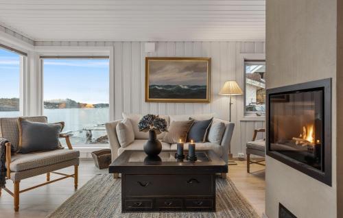 a living room with a couch and a fireplace at Gorgeous Home In Sandefjord With Wifi in Sandefjord