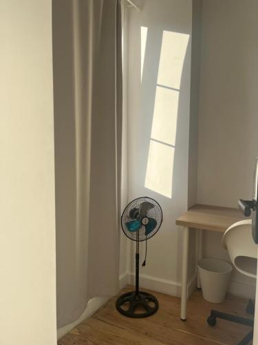 a small fan in a bathroom next to a sink at Bang Bang in Lisbon