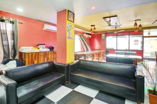 a waiting room with black leather seats in a restaurant at Hotel O ROYAL REGENCY, Pathsala in Barpeta