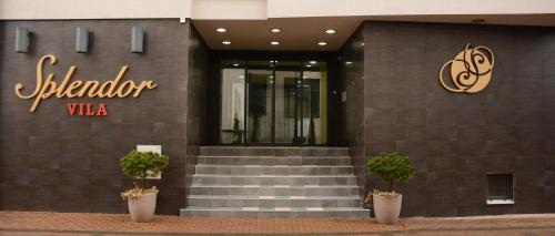 a building with a staircase and a sign on it at Apartments Villa Splendor in Vrnjačka Banja