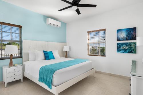a bedroom with a bed and a ceiling fan at Ridge 2 Bedroom in Grand Turk
