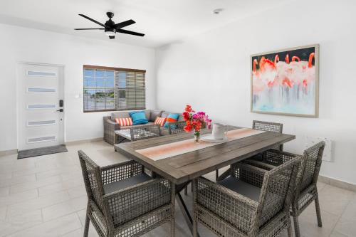 a dining room with a wooden table and chairs at Ridge 2 Bedroom in Grand Turk