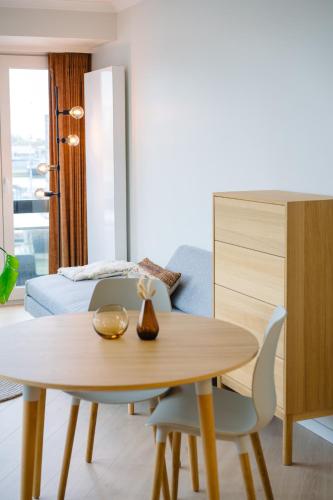 a living room with a table and a bedroom at Hotel du Bassin in Ostend