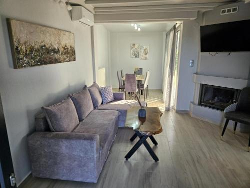 a living room with a couch and a table at OLYMPUS Paradise 1 in Skotína