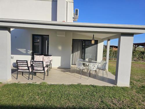 a patio with chairs and a table on a house at OLYMPUS Paradise 1 in Skotína