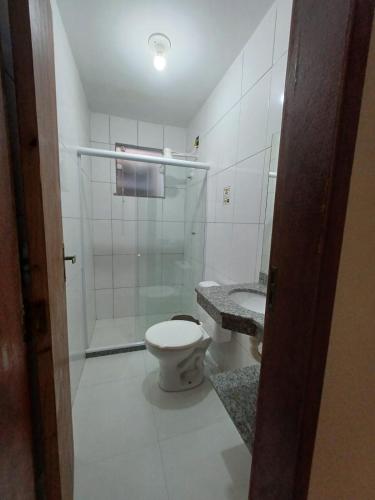 a bathroom with a shower and a toilet and a sink at Pousada Estrela Mares 209 in Cabo Frio