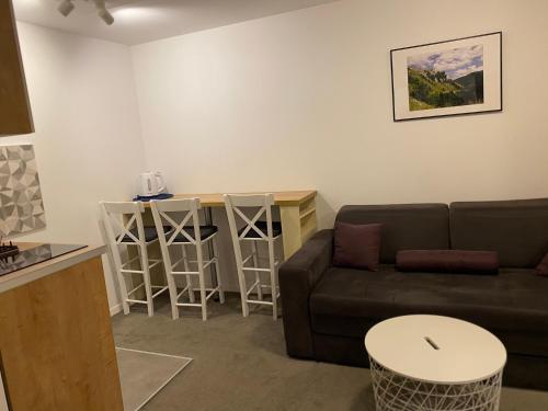 uma sala de estar com um sofá e uma mesa em Vuk & Sofija Apartmani em Kopaonik