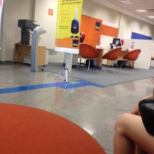 a room with chairs and a table and a sign at Apartamento Albuquerque in Mauá