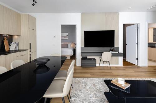 a kitchen and living room with a black table at Smithe House in Vancouver
