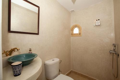 a bathroom with a sink and a toilet at riad dar wlidati in Marrakech