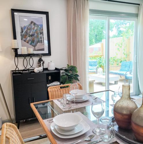 a dining room with a glass table and chairs at Relax Near Chattanooga at cozy Magdelaine House in Fort Oglethorpe