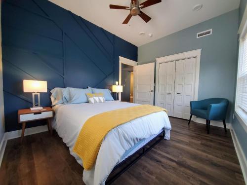 a blue bedroom with a bed and a blue wall at Pickwick Places 201 in Springfield