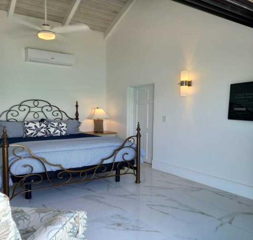 a bedroom with a blue bed with a lamp on it at Las Brisas Azules in Providenciales