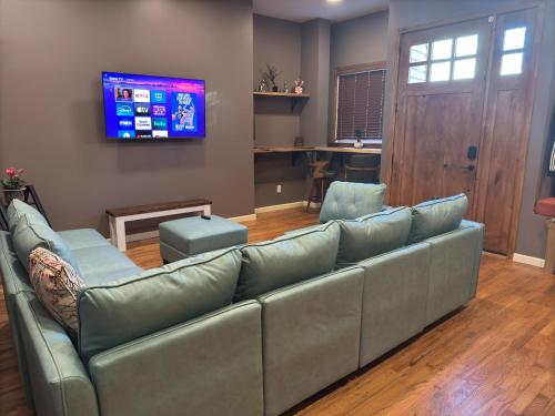 a living room with a couch and a television at NEW Modern Private Entrance 2 BD Apt Minutes to NYC in Jersey City