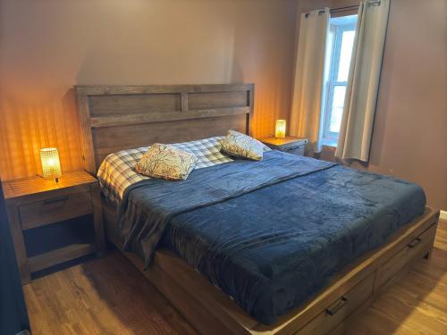 a bed with two pillows on it in a bedroom at NEW Modern Private Entrance 2 BD Apt Minutes to NYC in Jersey City