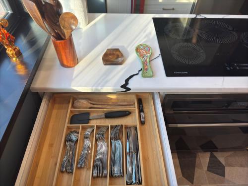 a drawer in a kitchen with utensils in it at NEW Modern Private Entrance 2 BD Apt Minutes to NYC in Jersey City