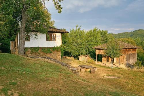 an old house on the side of a hill at Authentic House with Stunning Mountain View - Karashka in Apriltsi
