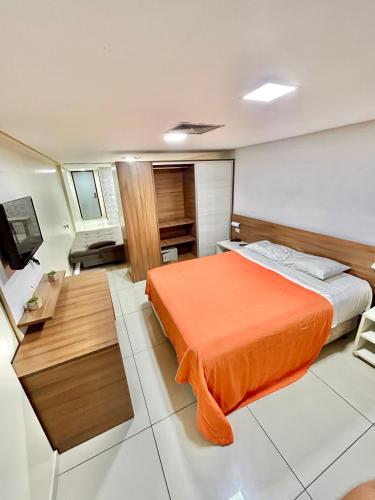 a hotel room with a bed and a desk at Beira Mar Imperial Flat 612 in João Pessoa