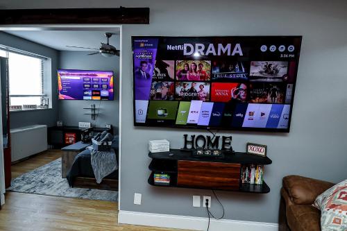 a living room with a tv hanging on the wall at Highrise DTWN 3 Bed Condo w King Bed in Atlanta