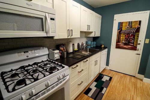 a kitchen with a stove and a microwave at Highrise DTWN 3 Bed Condo w King Bed in Atlanta
