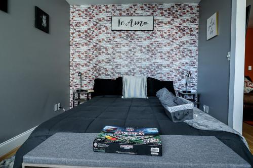 a bedroom with a bed and a brick wall at Highrise DTWN 3 Bed Condo w King Bed in Atlanta