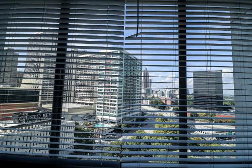 a view of a large city through a window at Highrise DTWN 3 Bed Condo w King Bed in Atlanta