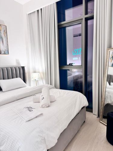 a hotel room with two beds and a window at Burj Khalifa view modern 1BHK with balcony in Dubai