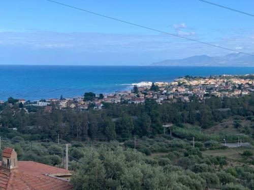 a town on a hill with the ocean in the background at Trabia Casa Bianca A in Mandra Capreria