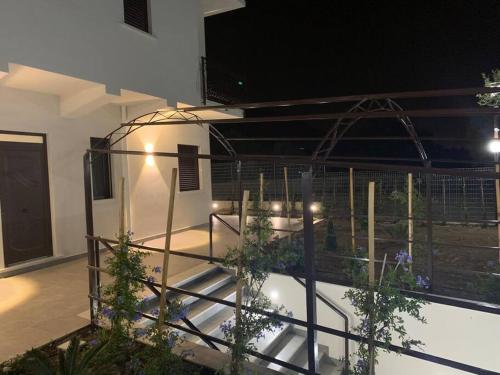 a balcony with stairs with plants on it at night at Trabia Casa Bianca A in Mandra Capreria