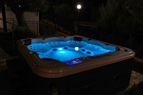 a hot tub in a backyard at night at Trabia Casa Bianca A in Mandra Capreria