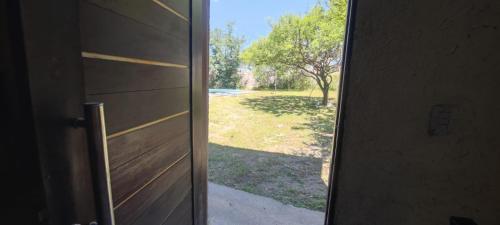 an open door with a view of a yard at Cabaña el diquecito in La Calera