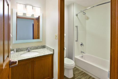 a bathroom with a sink and a toilet and a tub at TownePlace Suites by Marriott Brookfield in Brookfield