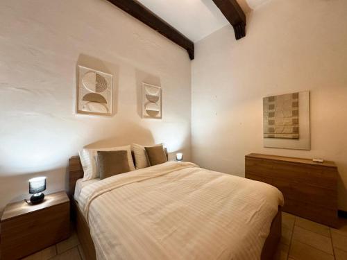 a bedroom with a bed and two pictures on the wall at Madliena Hills Mansion in Is-Swieqi