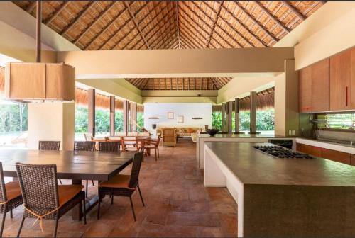 a kitchen and dining room with a table and chairs at Astonishing 5BR Villa at Mesa de Yeguas in Anapoima