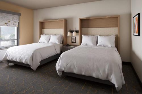 a hotel room with two beds and a window at Holiday Inn - Clarksville Northeast by IHG in Clarksville