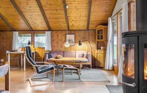 a living room with a table and a couch at 3 Bedroom Beautiful Home In Hundested in Hundested
